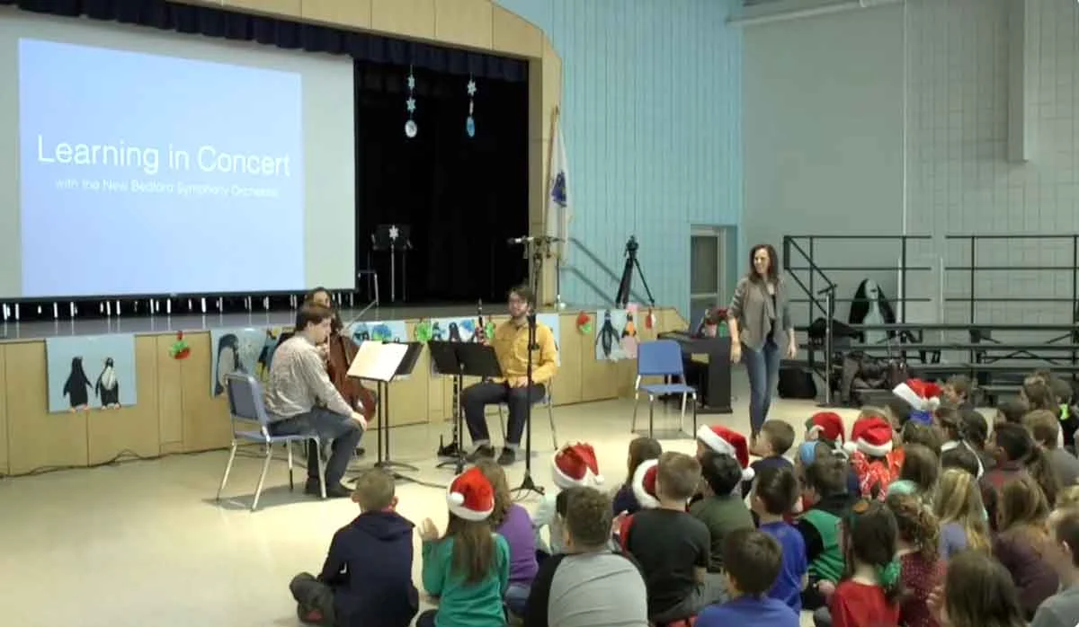 Children learning about music in classroom setting.